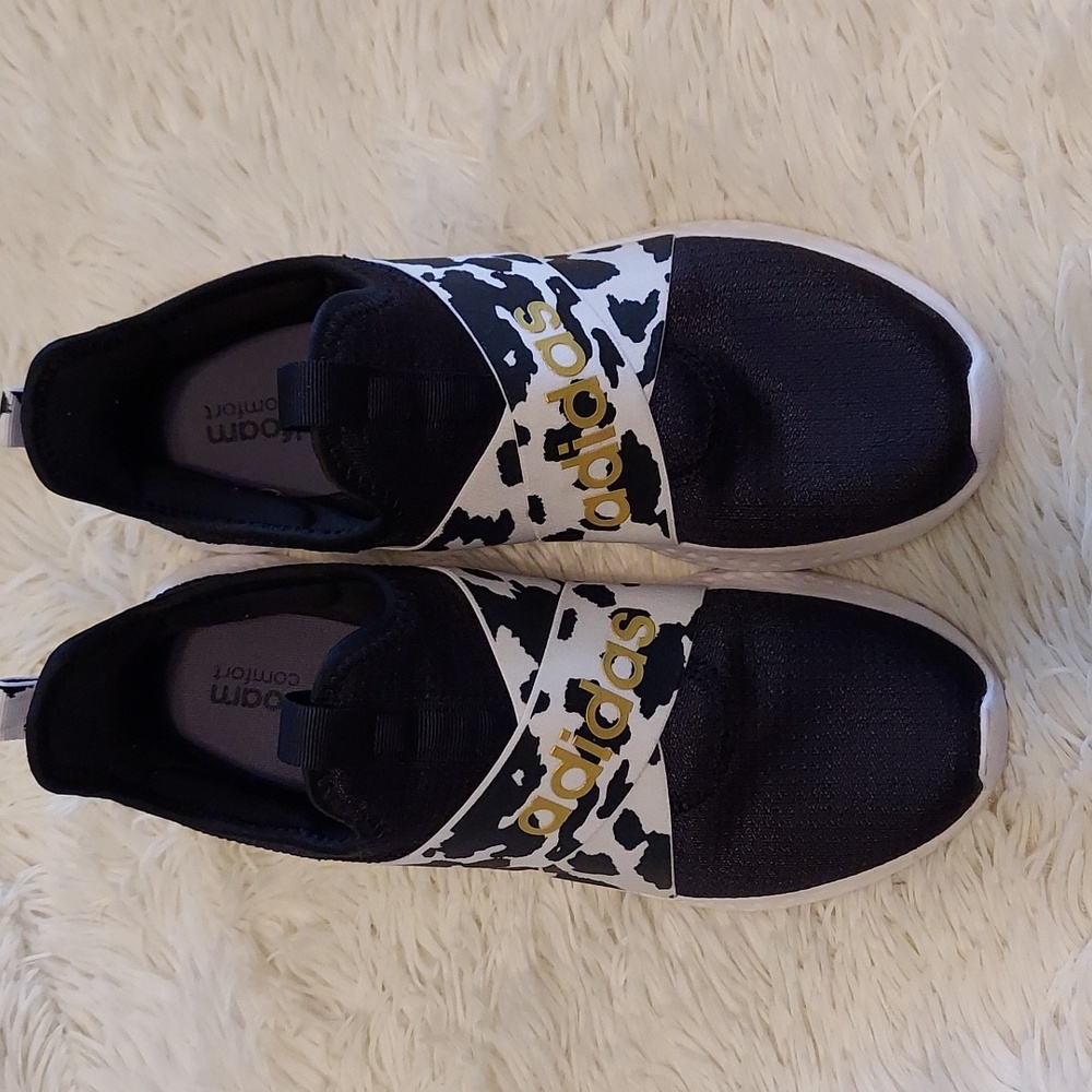 Black, white, and gold slip on Adidas